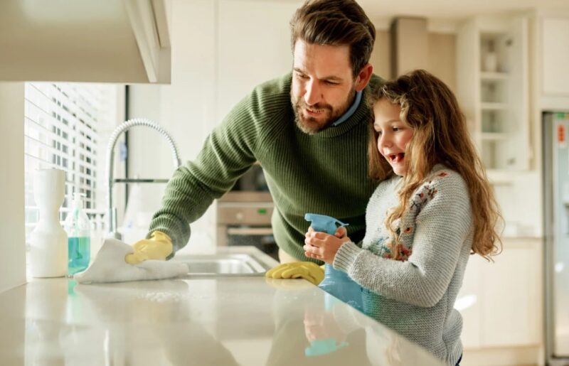 Father and Daughter Cleaning Kitchen with Homemade Kitchen Products. Organic Kitchen Cleaners