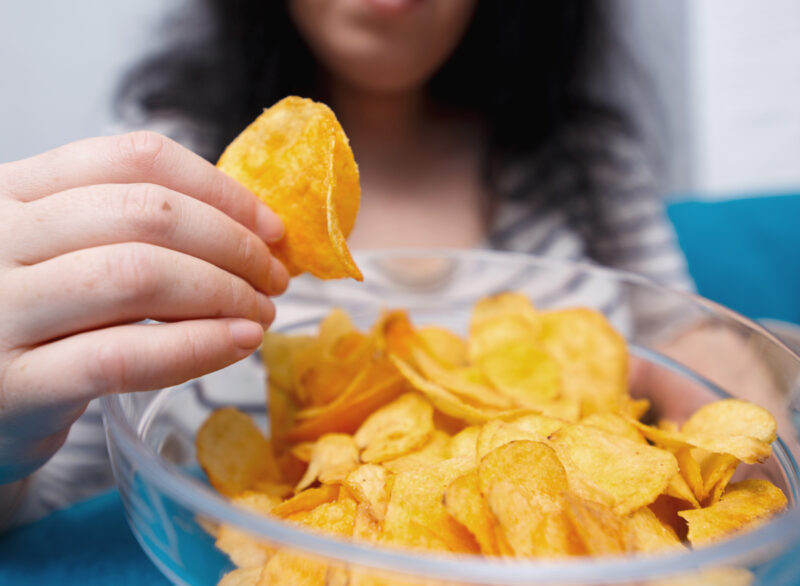 Woman eating Takis