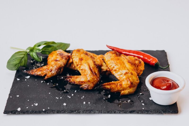 chicken wings with papper on stone plate